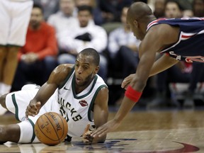 Milwaukee Bucks guard DeAndre Liggins, left, and Washington Wizards guard Jodie Meeks scramble for the ball during the second half of an NBA basketball game Saturday, Jan. 6, 2018, in Washington. The Bucks won 110-103.