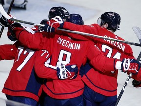 Teammates surround Washington Capitals left wing Alex Ovechkin (8), from Russia, after his goal in the third period of an NHL hockey game against the St. Louis Blues, Sunday, Jan. 7, 2018, in Washington.