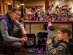 Nick Spicher, a new program innovation manager at Everett's Imagine Children's Museum, talks with Ezra Tamas, 5, Wednesday, while the youngster builds things with educational toys called brackitz. Ezra, who will turn 6 in a few days, goes to the museum nearly every week with his mom Estera Tamas.