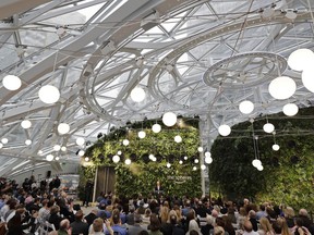 Guests listen as Jeff Bezos, the CEO and founder of Amazon.com, speaks during the grand opening of the Amazon Spheres, Monday, Jan. 29, 2018, in Seattle.