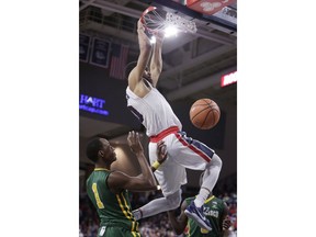 Gonzaga guard Silas Melson, right, dunks in front of San Francisco guard Jamaree Bouyea (1) during the first half of an NCAA college basketball game in Spokane, Wash., Saturday, Jan. 27, 2018.