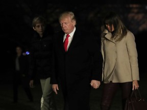 President Donald Trump together with first lady Melania Trump and their son Barron Trump returns to the White House in Washington, Monday, Jan. 1, 2018, from a holiday break at his Mar-a-Lago estate in Palm Beach, Fla.