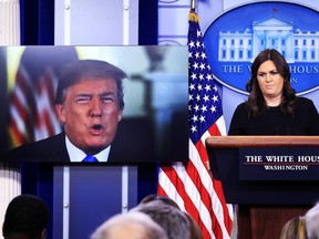President Donald Trump speaks via a video monitor to journalists in the Brady press briefing at the White House in Washington during the daily press briefing with press secretary Sarah Huckabee Sanders, Thursday, Jan. 4, 2018.