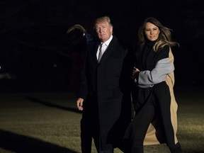 President Donald Trump walks on the South Lawn with first lady Melania Trump and their son Barron Trump upon arrival at the White House in Washington, Monday, Jan. 15, 2018. Trump spent the holiday weekend at his Mar-a-Lago estate in Palm Beach, Fla.