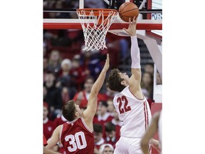Wisconsin's Ethan Happ (22) shoots against Indiana's Collin Hartman (30) during the first half of an NCAA college basketball game Tuesday, Jan. 2, 2018, in Madison, Wis.
