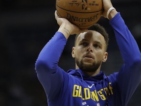 Golden State Warriors' Stephen Curry shoots before an NBA basketball game against the Milwaukee Bucks Friday, Jan. 12, 2018, in Milwaukee.