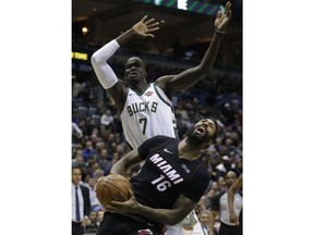 Miami Heat's James Johnson tries to drive past Milwaukee Bucks' Thon Maker during the first half of an NBA basketball game Wednesday, Jan. 17, 2018, in Milwaukee.