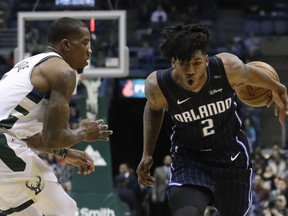 Orlando Magic's Elfrid Payton loses the ball in front of Milwaukee Bucks' Eric Bledsoe during the first half of an NBA basketball game Wednesday, Jan. 10, 2018, in Milwaukee.
