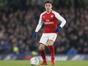 FILE - In this file photo dated Wednesday, Jan. 10, 2018, Arsenal's Alexis Sanchez during the English League Cup semifinal first leg soccer match between Chelsea and Arsenal at Stamford Bridge stadium in London.  Chilean player Sanchez has been left out of Arsenal's squad for the Premier League match against Bournemouth on Sunday Jan. 14, 2018, amid interest in the forward from Manchester City and Manchester United.