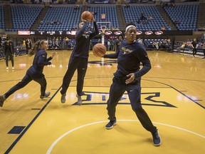 Members of the West Virginia team warm up before an NCAA college basketball game against Baylor in Morgantown, W.Va., Sunday, Jan. 28, 2018.