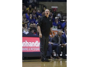 Kansas head coach Bill Self shouts a play to his players during the first half of an NCAA college basketball game against West Virginia, Monday, Jan. 15, 2018, in Morgantown, W.Va.
