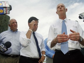 FILE - In this Aug. 13, 2013, file photo, Rep. Steve Southerland, R-Fla. and Sen. Marco Rubio listen to Florida Gov. Rick Scott announce a lawsuit against the state of Georgia, while touring Apalachicola, Fla. Florida is hoping the Supreme Court will come to the rescue of this slice of northwestern Florida, which the state says has been devastated by greedy water users in Georgia. The high court hears argument Monday, Jan. 8, 2018, in the long-running water war between the neighboring states.