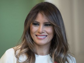 In this Nov. 27, 2017 photo, First lady Melania Trump smiles as she visits with children in the East Room of the White House in Washington.  Melania Trump has visited the U.S Holocaust Memorial Museum while her husband attends an economic forum in Davos, Switzerland. That's according to her spokeswoman, who tweeted on Thursday that the first lady has stopped by the memorial near the National Mall in Washington.