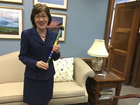 Sen. Susan Collins, R-Maine, holds a colorfully beaded 'talking stick' in her office on Capitol Hill in Washington, Monday, Jan. 22, 2018. At midmorning, Collins gathered a meeting about two dozen centrists from both parties in her office to try and get a deal to end the federal government shutdown. Collins' office had become known as Switzerland, an essential neutral place for both sides to talk. There was, at times, too much talking, Collins acknowledged. She employed the stick, given to her by her colleague, Sen. Heidi Heitkamp, D-N.D., to help bring order out of the chaos. Collins said the centrists agreed they'd support an end to the shutdown if McConnell could just slightly sweeten an offer he'd made the night before.