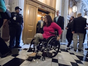 FILE - In this Aug. 3, 2017, file photo, Sen. Tammy Duckworth, D-Ill., followed by Sen. Thom Tillis, R-N.C., on Capitol Hill in Washington. Duckworth has announced that she's pregnant with her second child, making her the first senator to give birth while in office.