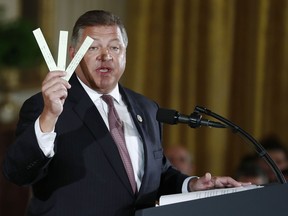 FILE - In this June 5, 2017, file photo, Rep. Bill Shuster, R-Pa., holds up papers slips used in air traffic control in the East Room of the White House in Washington during a ceremony to announce the Air Traffic Control Reform Initiative. Shuster, the powerful GOP Chairman of the House Transportation and Infrastructure panel, says he won't run for re-election. Shuster says he wants to focus his time and energy on working with President Donald Trump on legislation to spend hundreds of billions of dollars to build roads, bridges, and other infrastructure.