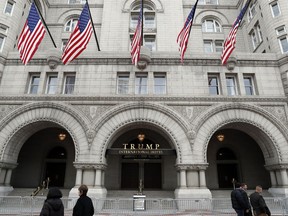 FILE- In this Dec. 21, 2016, file photo, the Trump International Hotel in Washington is shown. A federal judge in Maryland hints that a recent New York court ruling might not sway him from considering whether President Donald Trump's business empire violates the emoluments clause of the Constitution.