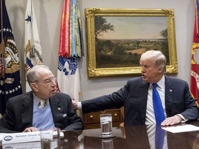 FILE - In this Jan. 4, 2018, President Donald Trump, accompanied by Sen. Chuck Grassley, R-Iowa, left, speaks at a meeting in the Roosevelt Room at the White House in Washington. Republicans who spent the early months of 2017 working with Democrats on investigations into Russian interference in U.S. elections have pivoted as the new year begins, leaving the conclusions of those congressional probes in doubt.