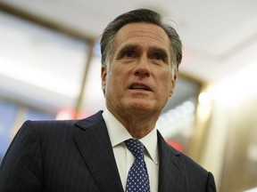 FILE - In this Nov. 29, 2016, file photo, Mitt Romney talks with reporters after eating dinner with then President-elect Donald Trump at Jean-Georges restaurant in New York. Romney was treated for prostate cancer in 2017. That's according to a Romney aide who spoke on the condition of anonymity to discuss a sensitive health issue. The aide said Jan. 8, 2018, that Romney was diagnosed with "slow-growing prostate cancer" and the cancer was removed surgically and found not to have spread beyond the prostate, the aide continued.