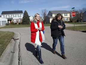 Rachel Farmer, left, a volunteer with Susan B Anthony List, canvasses a neighborhood alongside Michelle Ashley, field director of southwest Ohio, right, Friday, Dec. 8, 2017, in West Chester, Ohio. Anti-abortion activists say their movement shows signs of success a year into President Donald Trump's administration. That's partly due to Trump's support and Vice President Mike Pence's commitment to curbing the practice made legal nearly 45 years ago.