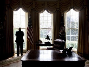 President Donald Trump poses for a photograph in the Oval Office in Washington, Wednesday, April 19, 2017.