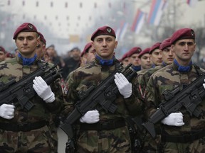 Members of the police forces of Republic of Srpska stand guard moments before a parade marking the 26th anniversary of the Republic of Srpska in the Bosnian town of Banja Luka, on Tuesday, Jan. 9, 2018. The Jan. 9 holiday commemorates the date in 1992 when Bosnian Serbs declared the creation of their own state in Bosnia, igniting the country's devastating 4-year war.
