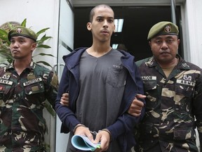 Spanish national Abdelhakim Labidi Adib is escorted by army troopers after attending proceedings at the Department of Justice in Manila, Philippines, Wednesday Jan. 24, 2018. Army troops have captured Spanish national Adib who they say was carrying grenades and bomb parts and is believed to be supporter of Islamic State group-linked Abu Sayyaf militants on southern Basilan island.