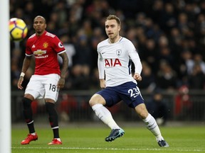 Tottenham's Christian Eriksen, right, scores the opening goal during the English Premier League soccer match between Tottenham Hotspur and Manchester United at Wembley stadium in London, England, Wednesday, Jan. 31, 2018.