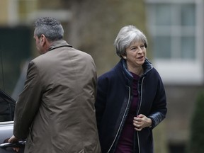Britain's Prime Minister Theresa May returns to 10 Downing Street in London, Monday, Jan. 8, 2018, ahead of an expected Cabinet reshuffle. The British Prime Minister is preparing to shuffle her Cabinet as she tries to bolster her authority ahead of a crucial new phase in Brexit negotiations.