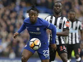 Chelsea's Michy Batshuayi, left, vies for the ball with Newcastle United's Henri Saivet during the English FA Cup fourth round soccer match between Chelsea and Newcastle United at Stamford Bridge stadium in London, Sunday, Jan. 28, 2018 .