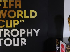 The FIFA World Cup trophy stands on a pedestal on board an aircraft on the first leg of the soccer FIFA Wold Cup 2018 trophy tour at Stansted Airport, England, Monday, Jan. 22, 2018. The trophy will visit some 50 countries as it make its journey round the world to Moscow for the start of the World Cup 2018 in Russia.