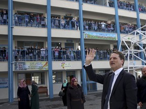 Mr. Pierre Krähenbühl, Commissioner-General of the United Nations Relief and Works Agency for Palestine Refugees, waves to refugee school girls on his arrival for a press conference to launch the global campaign to support UNRWA, at the UNRWA Rimal Girls Preparatory School in Gaza City, Monday, Jan. 22, 2018. The main U.N. agency for Palestinian refugees launched an "unprecedented" appeal seeking hundreds of millions of dollars in response to funding cuts by the Trump administration.