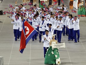 FILE - In this Sept. 19, 2014, file photo. athletes from North Korea march into the stadium during the opening ceremony for the 17th Asian Games in Incheon, South Korea. North Korea attended the Asian Games in Incheon, South Korea. At the close of the event, three top North Korean officials made a surprise visit and held the highest-level face-to-face talks with South Korea in five years.