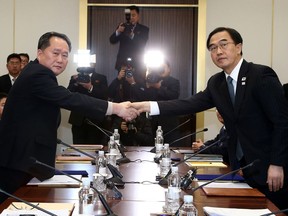 South Korean Unification Minister Cho Myoung-gyon, right, shakes hands with the head of North Korean delegation Ri Son Gwon during their meeting at the Panmunjom in the Demilitarized Zone in Paju, South Korea, Tuesday, Jan. 9, 2018. The rival Koreas took steps toward reducing their bitter animosity during rare talks Tuesday, as North Korea agreed to send a delegation to next month's Winter Olympics in South Korea and reopen a military hotline. (Korea Pool via AP)