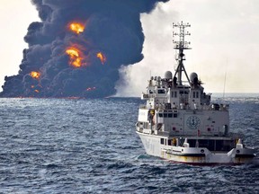 In this Sunday, Jan. 14, 2018, photo provided by China's Ministry of Transport, a rescue ship sails near the burning Iranian oil tanker Sanchi in the East China Sea off the eastern coast of China. The fire from the sunken Iranian tanker ship in the East China Sea has burned out, a Chinese transport ministry spokesman said Monday, although concerns remain about possible major pollution to the sea bed and surrounding waters. (Ministry of Transport via AP)