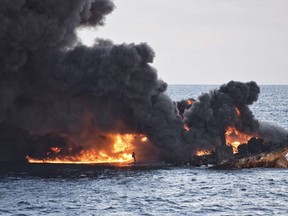 In this Sunday, Jan. 14, 2018 photo provided by China's Ministry of Transport, the burning Iranian oil tanker Sanchi is seen partially sunk in the East China Sea off the eastern coast of China. The fire from the sunken Iranian tanker ship in the East China Sea has burned out, a Chinese transport ministry spokesman said Monday, although concerns remain about possible major pollution to the sea bed and surrounding waters. (Ministry of Transport via AP)