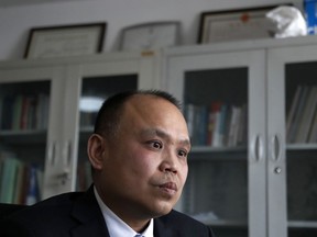FILE - In this Feb. 24, 2017, file photo, prominent legal activist Yu Wensheng pauses during an interview at his office in Beijing. Yu has been charged with inciting subversion of state power after writing a letter calling for democratic reforms, his lawyer said Monday, Jan. 29, 2018.