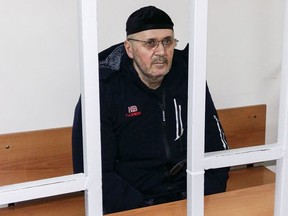 Oyub Titiyev, the head of regional branch of Russian human rights group Memorial attends a court hearing in Grozny, Russia, Thursday, Jan. 25, 2018. Titiyev has been in custody since his arrest earlier this month on drug possession charges that Memorial said described as trumped up.