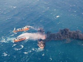 FILE - In this Wednesday, Jan. 10, 2018, photo provided by China's Ministry of Transport, firefighting boats work to put on a blaze on the oil tanker Sanchi in the East China Sea off the eastern coast of China. A Chinese official said Friday, Jan. 19, 2018, that the explosion and sinking of an Iranian oil tanker in the East China Sea was without precedent, creating enormous difficulties for rescue and recovery efforts. (Ministry of Transport via AP, File)