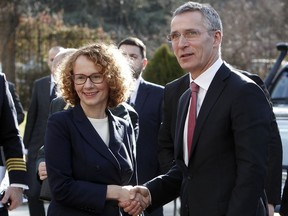 NATO Secretary General Jens Stoltenberg, right, is welcomed by Macedonian Defense Minister Radmila Sekerinska Jankovska upon his arrival at the Defense Ministry in Skopje, Macedonia, Thursday, Jan. 19, 2018. NATO's secretary-general is due in Macedonia for talks on the country's renewed accession bid, a decade after a dispute with neighboring Greece halted an initial effort to join the alliance.