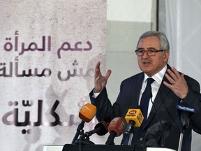 In this Wednesday, Jan. 17, 2018 photo, State Minister of Women's Affairs, Jean Oghassabian, speaks during a conference on women participation in politics, at Kempinski Summerland Hotel in Beirut, Lebanon. Oghassabian said he is campaigning for five times more women to be elected to parliament. Lebanon is holding its first parliamentary elections in nearly ten years in May. The government and local groups, with help from the United Nations and the European Union, are campaigning to get at least five times more women elected to the parliament, a daunting task in this country that may look like the Middle East's most liberal. The banner behinds him in Arabic that reads: "Supporting women is not a formality."