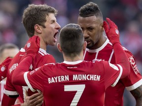 FILE - In this Jan.21, 2018 file photo, Munich's scorer Thomas Mueller, Franck Ribery and Jerome Boateng, from left celebrate after their side's first goal during the German first division Bundesliga soccer match between Bayern Munich and Werder Bremen in Munich, Germany.  Bayern Munich's dominance of the Bundesliga is hurting the league and likely to have a detrimental effect on the club itself.