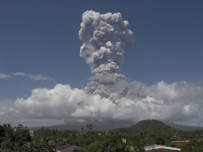 A huge column of ash shoots up to the sky during the eruption of Mayon volcano Monday, Jan. 22, 2018 as seen from Legazpi city, Albay province, around 340 kilometers (200 miles) southeast of Manila, Philippines. The Philippines' most active volcano erupted Monday prompting the Philippine Institute of Volcanology and Seismology to raise the Alert level to 4 from last week's alert level 3.