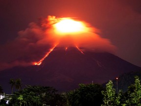 Lava cascades down the slopes of Mayon volcano as seen from Legazpi city, Albay province, around 340 kilometers (210 miles) southeast of Manila, Philippines, Monday, Jan. 15, 2018. More than 9,000 people have evacuated the area around the Philippines' most active volcano as lava flowed down its crater Monday in a gentle eruption that scientists warned could turn explosive.