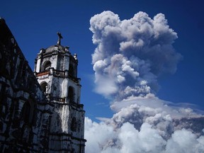 A huge column of ash shoots up to the sky during the eruption of Mayon volcano Monday, Jan. 22, 2018 as seen from Daraga township, Legazpi city, Albay province, around 340 kilometers (200 miles) southeast of Manila, Philippines. The Philippines' most active volcano erupted Monday prompting the Philippine Institute of Volcanology and Seismology to raise the Alert level to 4 from last week's alert level 3.