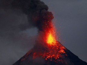 Mayon volcano spews red-hot lava in another eruption as seen from Legazpi city, Albay province, roughly 340 kilometers southeast of Manila, Philippines, Tuesday, Jan. 23, 2018.