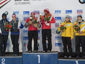 From left: Second placed Aja Evans and Jamie Greubel Poser, from the U.S.  Canada's winners Kaillie Humphries und Phylicia George, and Germany's third placed  Anna Koehler und Annika Drazek, celebrate on the podium after the women's bob competition at the Bob World Cup in Altenberg, Germany, Saturday, Jan. 6, 2018.