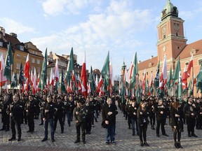 FILE - In this Saturday, April 29, 2017 file photo, members of a far-right group, the National-Radical Camp, march in Warsaw. Poland's government is facing pressure to deal with the phenomenon of a rising far-right following the weekend broadcast of an explosive report about Polish neo-Nazis.