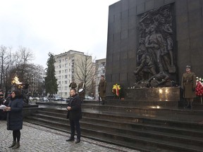 Israeli Ambassador to Poland, Anna Azari, standing left, speaks during a eremony markjng the 13th International Day of Commemoration in Memory of the victims of the Holocaust, at the Monument to the Heroes of the Warsaw Ghetto in Warsaw, Poland, Monday, Jan. 29, 2018.