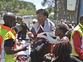 An injured passenger receives attention at the scene of a train accident near Kroonstad, South Africa, Thursday, Jan 4, 2018. South Africa's transport minister says at least 12 people died and more than 260 were injured in a collision between a truck and a passenger train. (AP Photo)